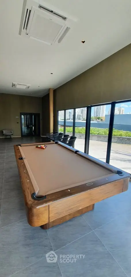 Luxurious common area with pool table and city view, perfect for entertainment and relaxation.
