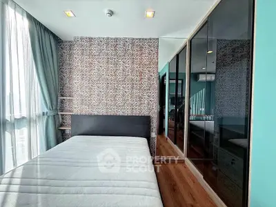 Modern bedroom with stylish wallpaper and large mirrored wardrobe