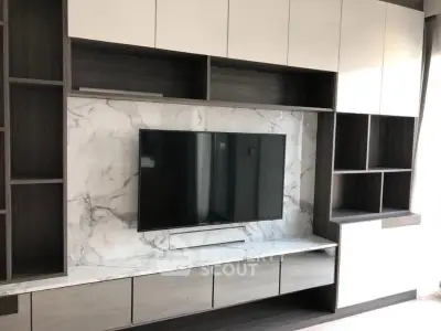 Modern living room with sleek TV unit and marble backdrop
