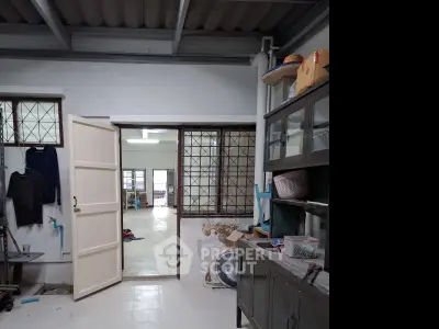 Spacious interior with open door leading to a bright room, showcasing potential for renovation.