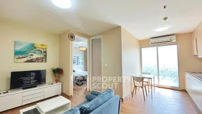 Modern open-plan living room with cozy seating and balcony access in a stylish apartment.
