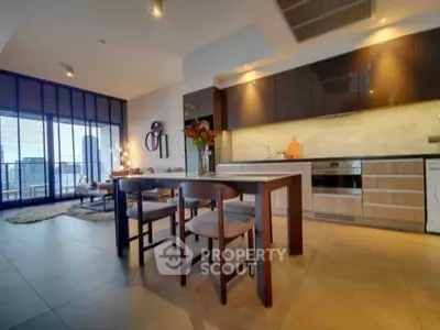 Modern open-layout kitchen with dining area and city view, featuring sleek cabinetry and stylish decor.