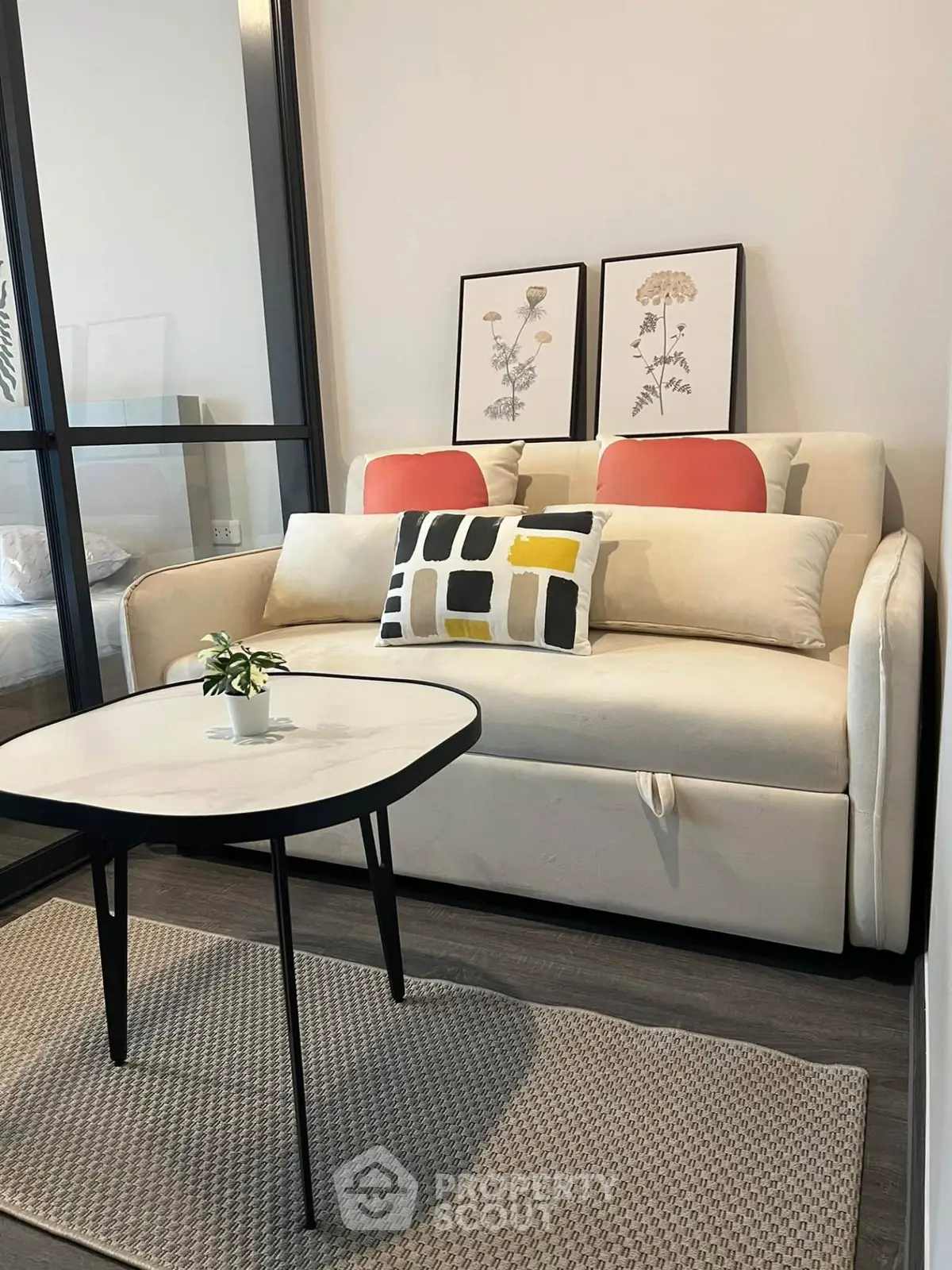 Modern living room with stylish sofa and decor in a cozy apartment setting.