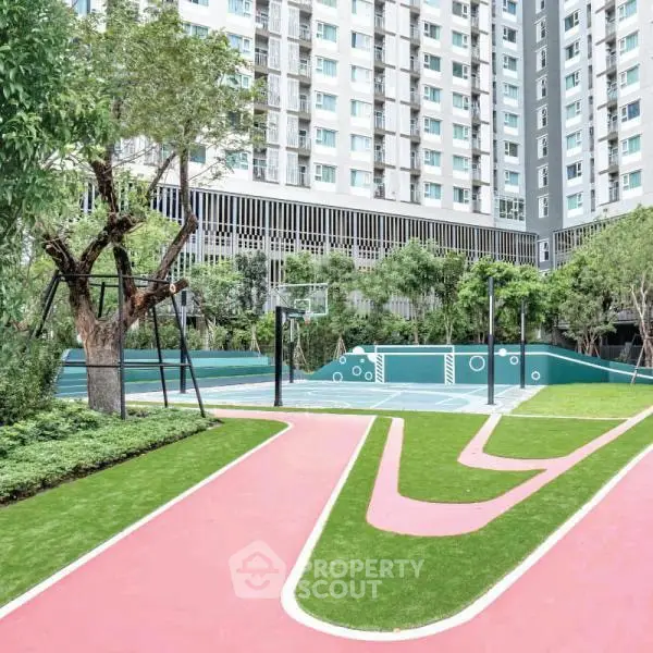 Modern residential building with lush garden and sports court, perfect for active urban living.