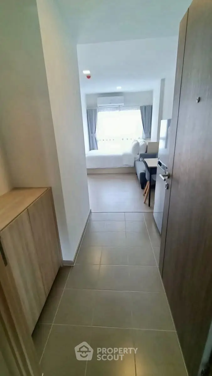 Modern apartment entrance leading to a bright living area with stylish decor.