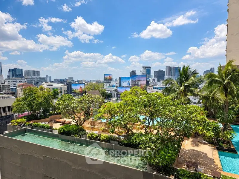Stunning cityscape view from a luxurious rooftop garden with pool and lush greenery.