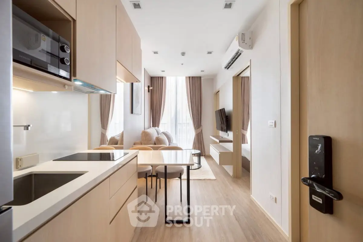 Modern open-layout kitchen and living room with sleek design and natural light