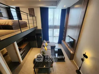 Modern loft apartment with open living area and mezzanine bedroom, featuring stylish decor and large windows.