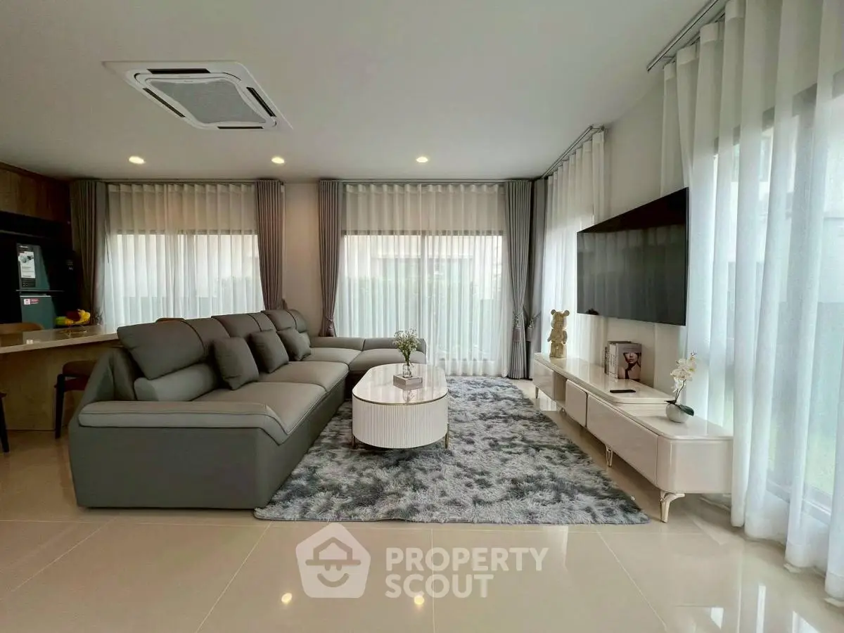 Spacious modern living room with elegant decor and large windows