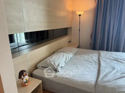 Modern bedroom with stylish wooden paneling and cozy lighting.