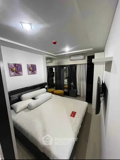Modern bedroom with stylish decor and comfortable bed in a contemporary apartment.