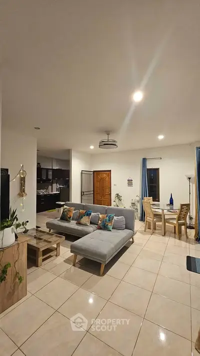 Spacious open-plan living room with modern decor and dining area