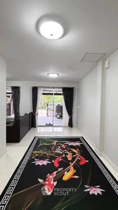 Spacious living room with elegant koi fish rug and modern lighting