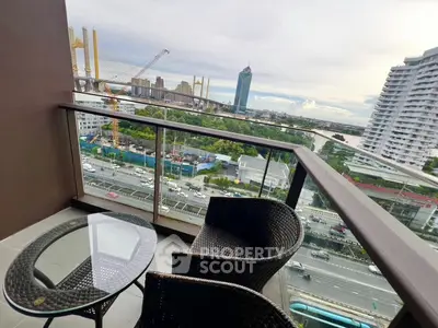 Stunning balcony view with modern cityscape and cozy seating area, perfect for relaxation and urban living.
