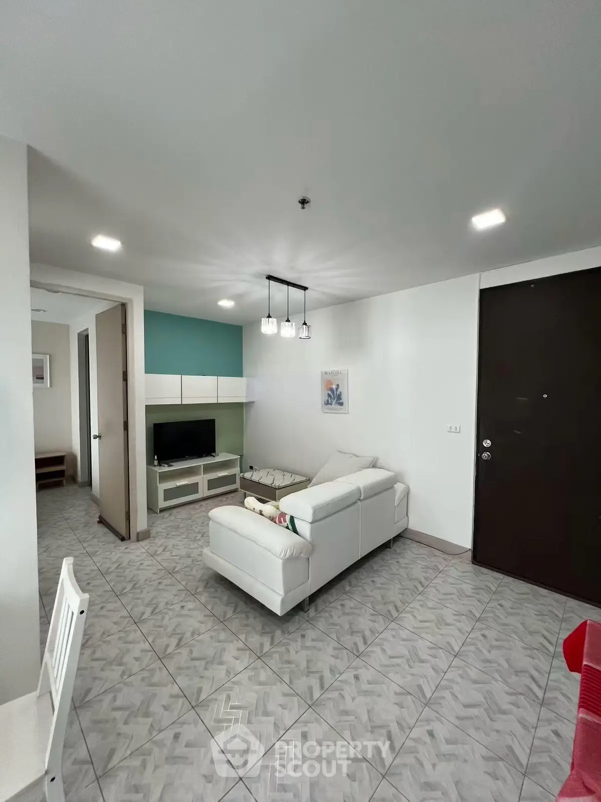 Modern living room with stylish decor and cozy seating in a contemporary apartment.
