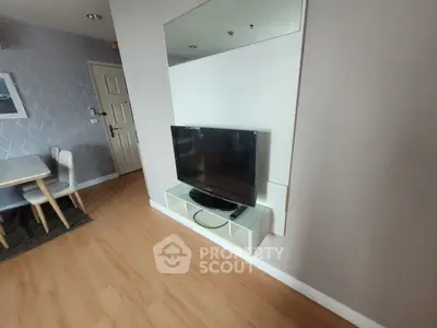 Modern living room with wall-mounted TV and stylish dining area