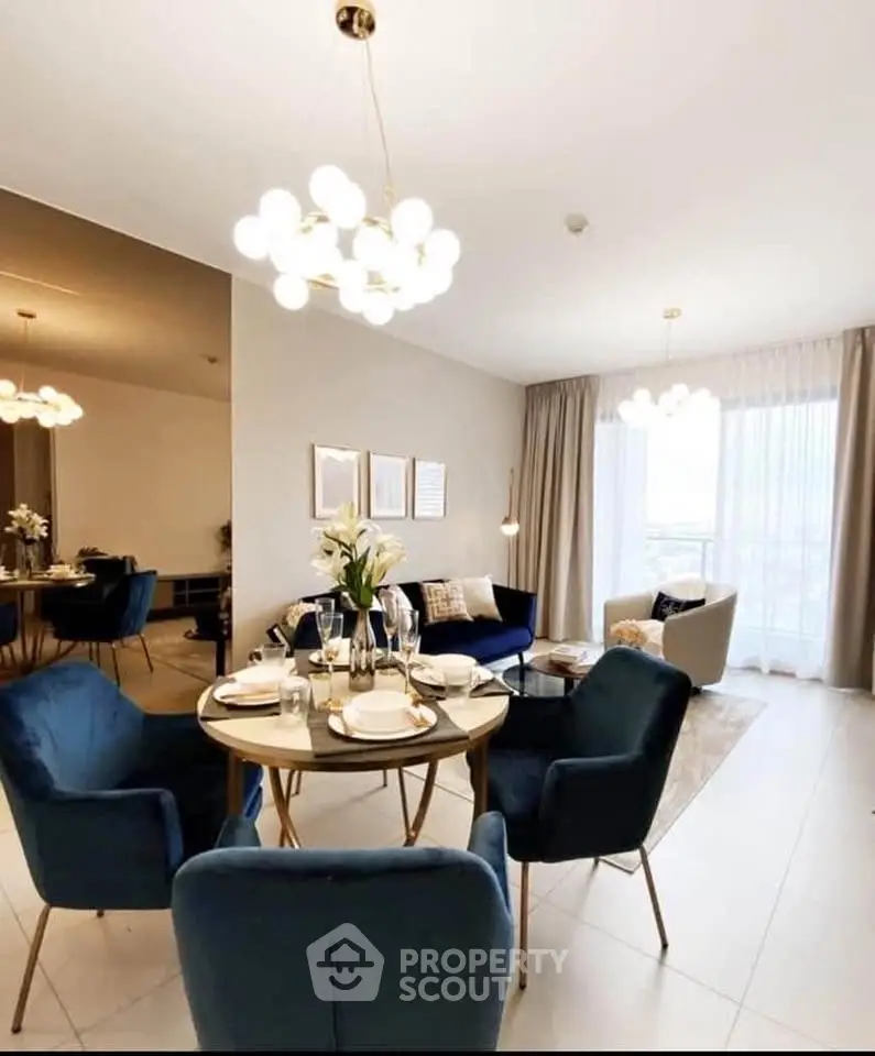 Elegant living room with modern dining area and stylish lighting, perfect for entertaining guests.