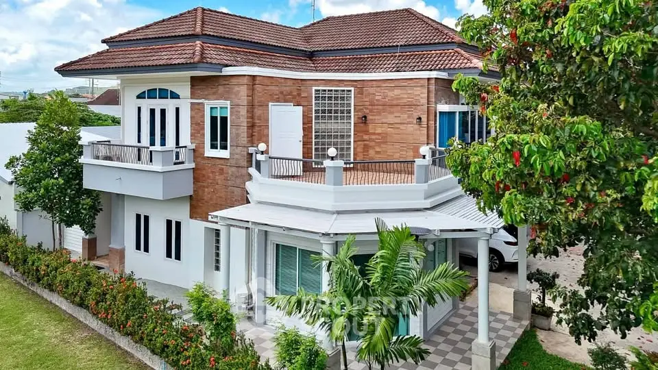 Stunning two-story brick house with lush garden and spacious balcony