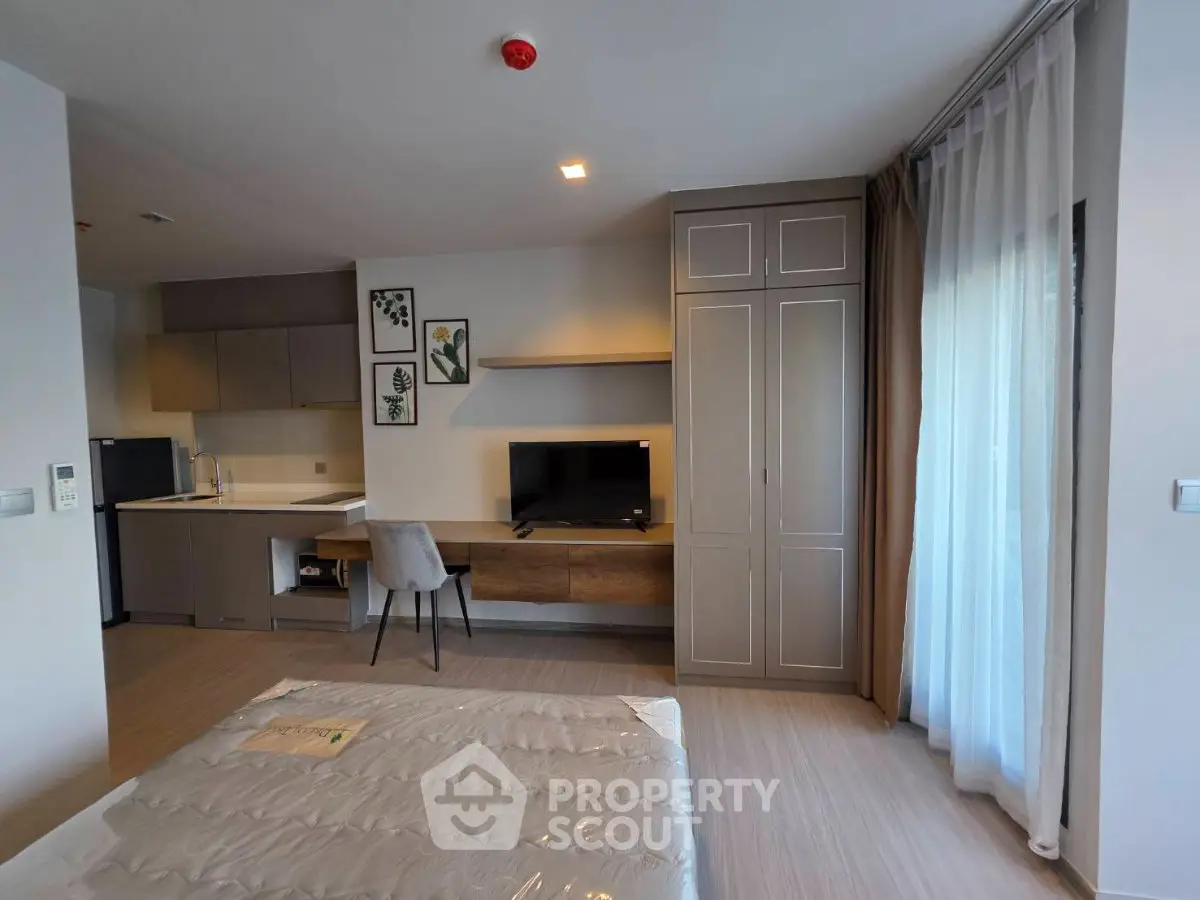 Modern studio apartment with stylish kitchen and cozy living area