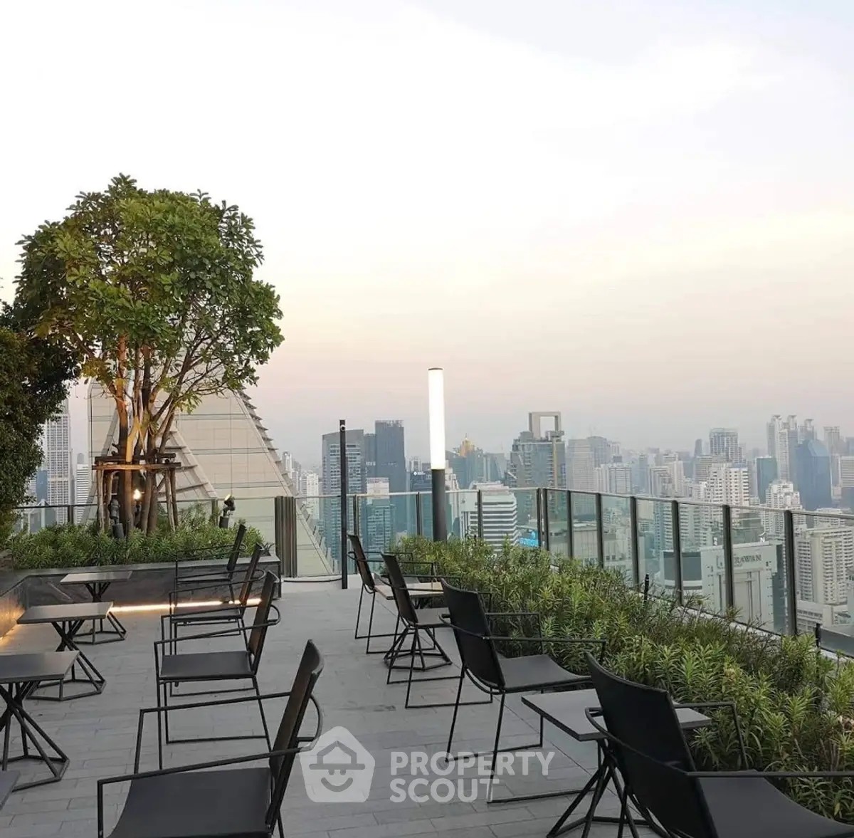 Stunning rooftop terrace with panoramic city skyline views and modern seating area.