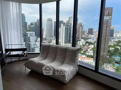 Luxurious high-rise apartment with panoramic city views and modern furnishings.