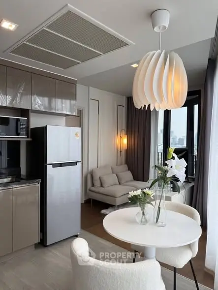 Modern open-layout kitchen and living area with stylish lighting and city view.