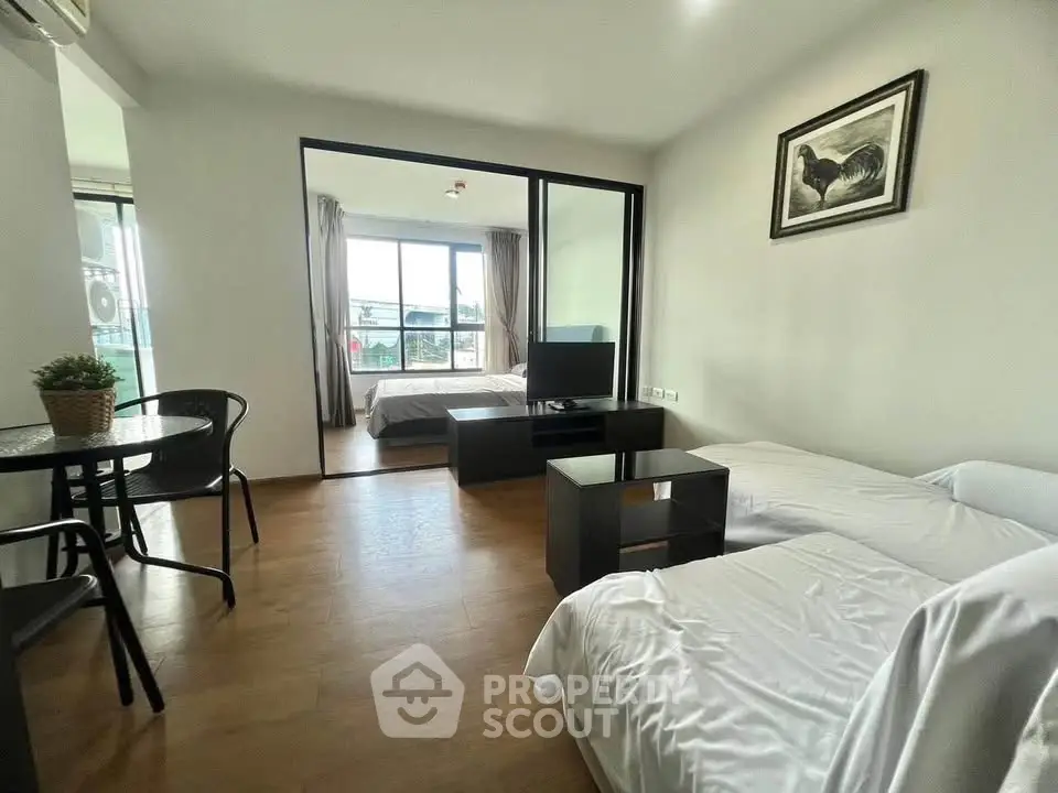 Modern living room with cozy seating and bedroom view