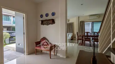 Elegant interior with classic furniture and open layout, featuring a cozy dining area and stylish decor.