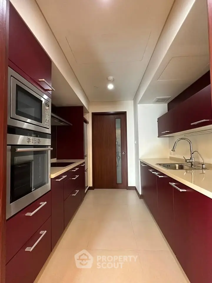 Modern kitchen with sleek cabinetry and built-in appliances in a stylish apartment.
