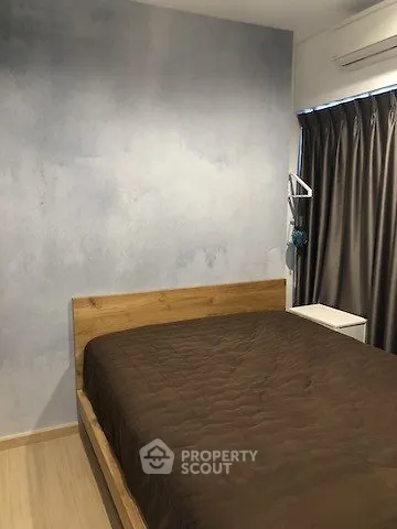 Cozy bedroom with wooden bed frame and modern decor
