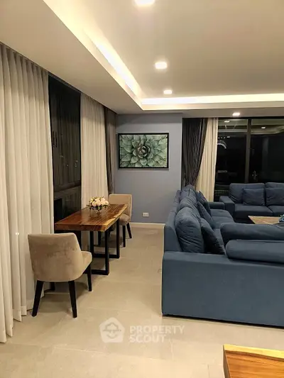 Spacious modern living room with elegant blue sofas and stylish decor