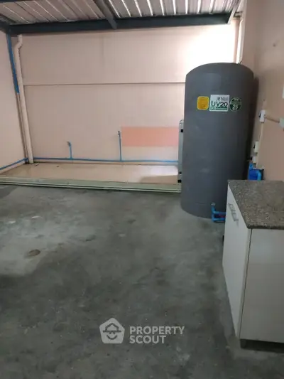Spacious garage with water tank and storage cabinet