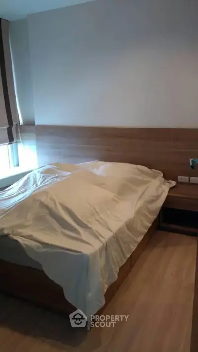 Cozy bedroom with wooden flooring and modern bed design