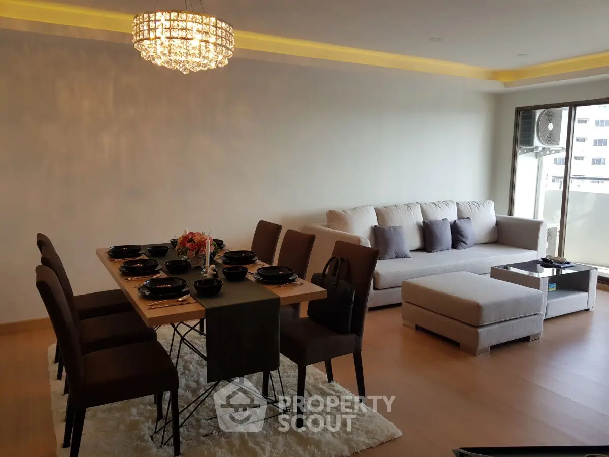 Elegant living room with modern dining set and plush sofa in a spacious open layout.
