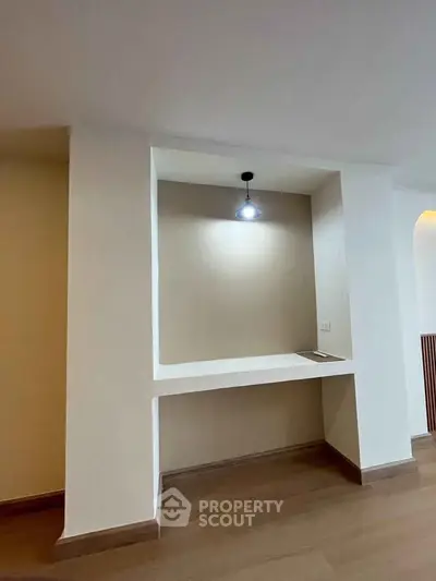 Modern interior nook with built-in desk and overhead lighting, perfect for a home office setup.