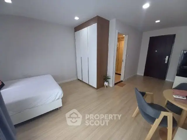 Modern bedroom with minimalist decor and wooden flooring