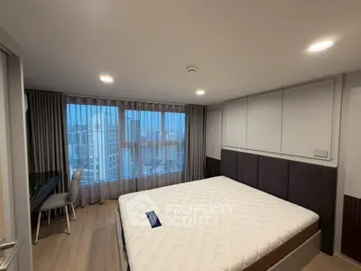 Spacious bedroom with city view and modern furnishings