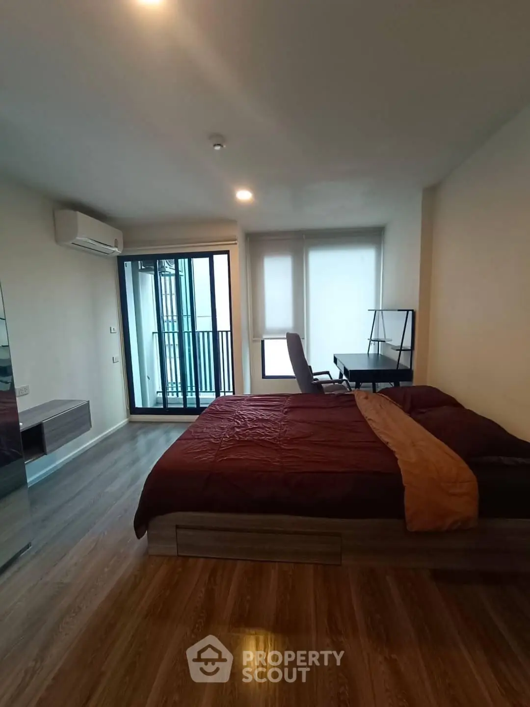 Spacious bedroom with modern decor and balcony access