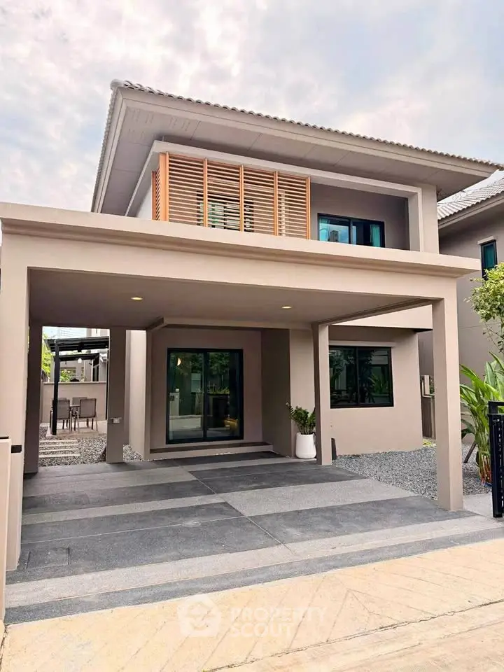 Modern two-story house with sleek design and spacious driveway in a serene neighborhood.
