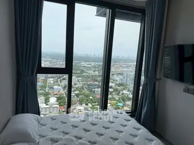 Stunning bedroom with panoramic city view from floor-to-ceiling windows.
