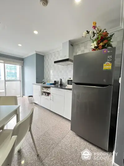 Modern kitchen with sleek appliances and stylish decor in a bright apartment