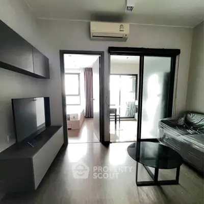 Modern living room with sleek furniture and large windows for natural light.