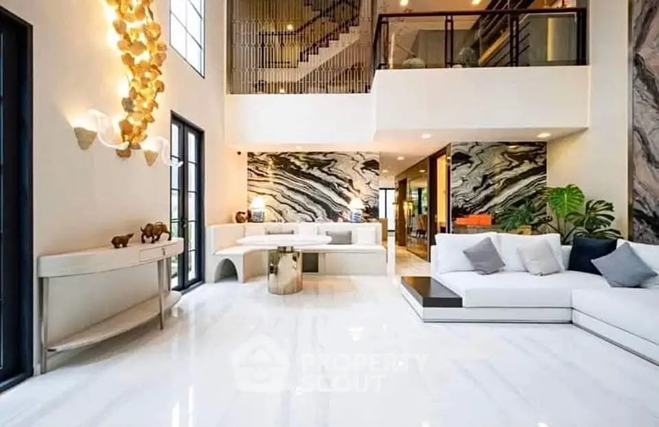 Luxurious modern living room with high ceilings and elegant marble accents