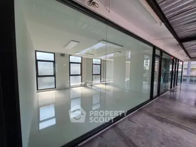 Modern office space with glass walls and natural light, ideal for businesses seeking a sleek and professional environment.