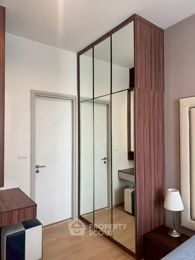 Modern bedroom with mirrored wardrobe and stylish decor