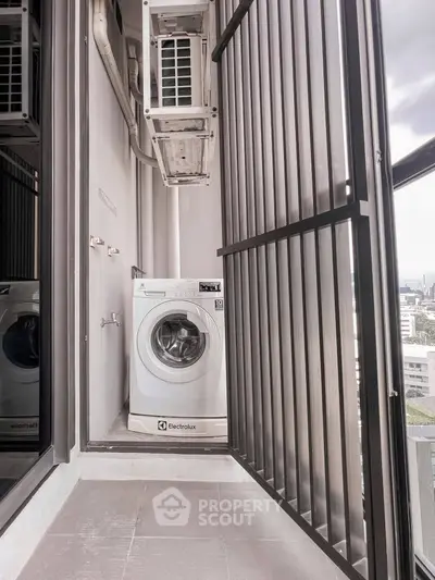 Compact balcony with washing machine and city view