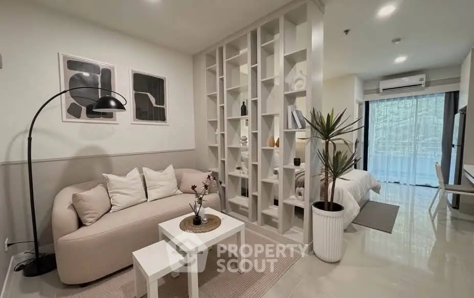 Modern open-plan living room with stylish decor and natural light