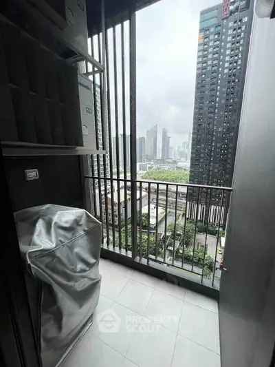 High-rise balcony with cityscape view and covered appliances.