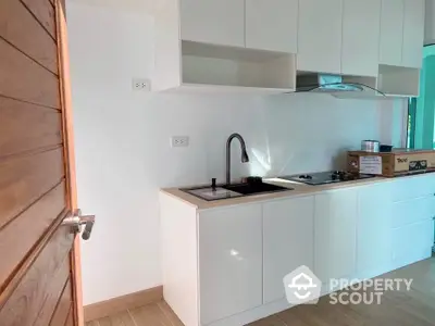 Modern kitchen with sleek white cabinets and gas stove in a bright interior