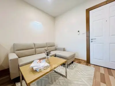 Cozy living room with modern beige sofa and stylish coffee table, perfect for relaxation.